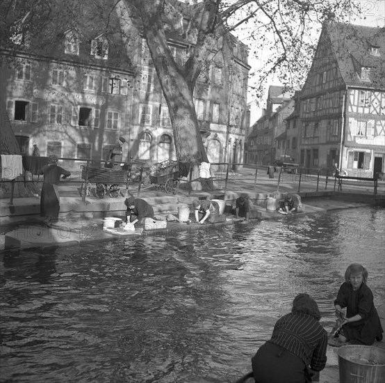 Housewives do their laundry on the banks of a river