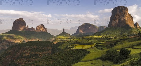 Rock formations and fields at the edge of Simien Mountains national park