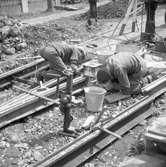 Construction workers laying tracks