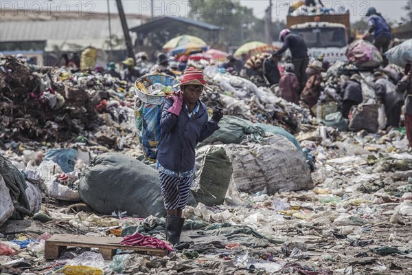 Garbage collectors on rubbish dump on the outskirts