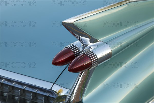 Tail fins with red tail lights of an american vintage car