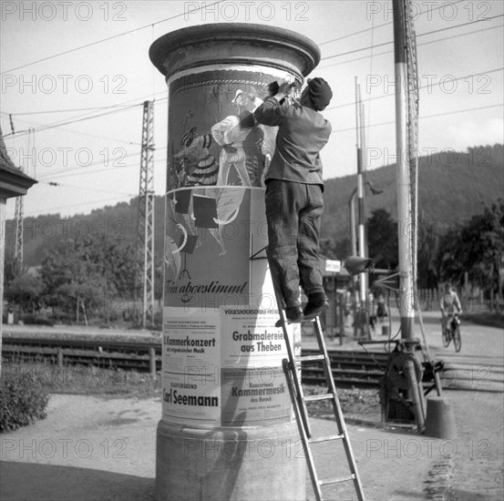 Advertising posters attached to advertising pillar ca. 1945