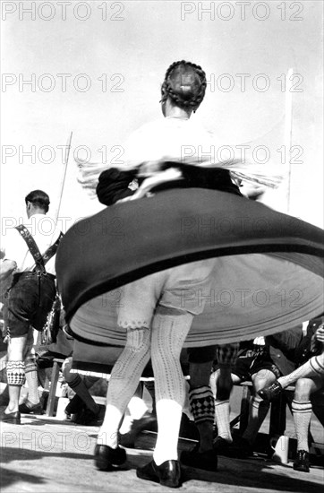 Dance in Bavarian traditional costume with view under the skirt