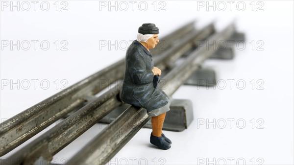 Grandmother figure waiting for the train