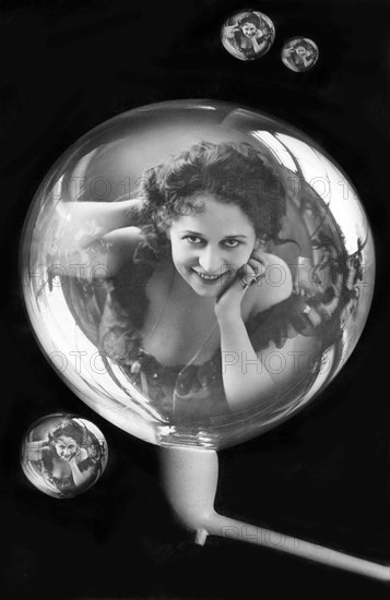 Woman reflected in soap bubbles