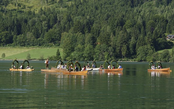 Men wearing traditional costumes in festively decorated squares