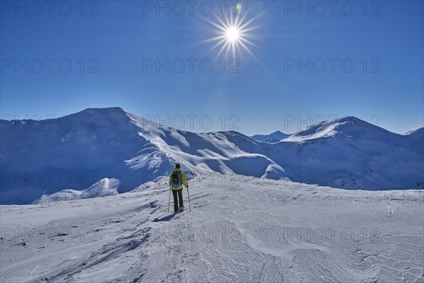 Brenner border crest with snowshoe hiker