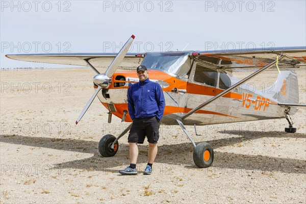 Man leaning against Cessna 170