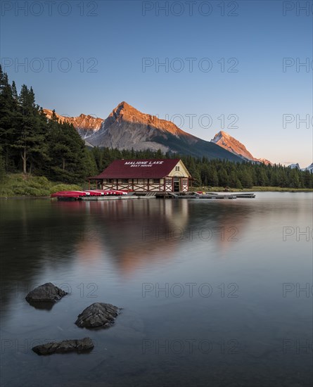 Boathouse with canoes on the shores of Maligne Lake