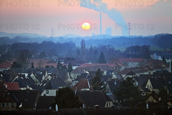 Housing estate with the Gersteinwerk power plant at sunset