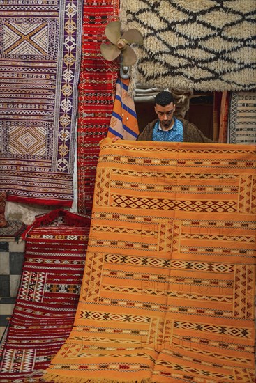 Carpet dealer shows a Moroccan carpet