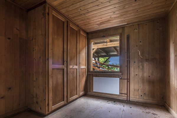 A room paneled with wood in a house that will be demolished