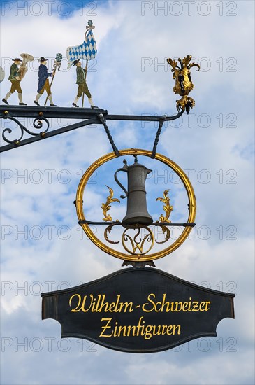 Hanging shop sign at the house of the tin foundry Schweizer in Diessen at Lake Ammer