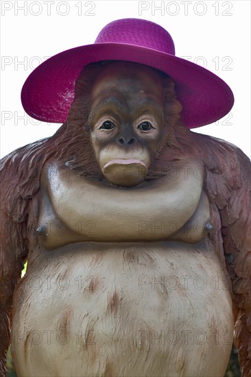 Orang Utan figure with purple sunhat