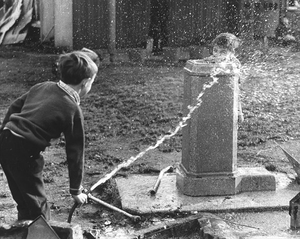 Children squirt with hose