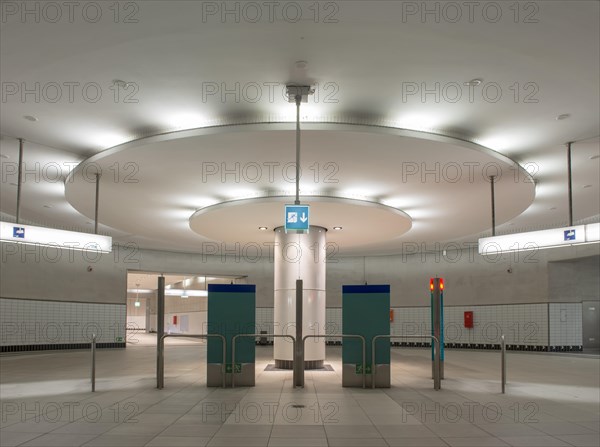 Illuminated column in entrance hall with ticket machine