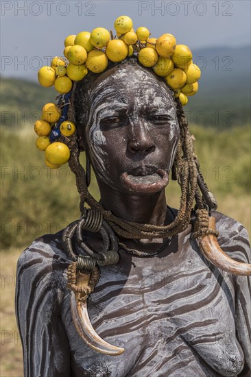 Woman with lip plate and headdress