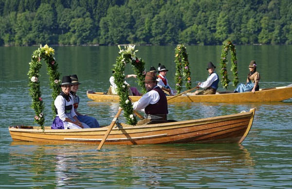 Men wearing traditional costumes in festively decorated squares