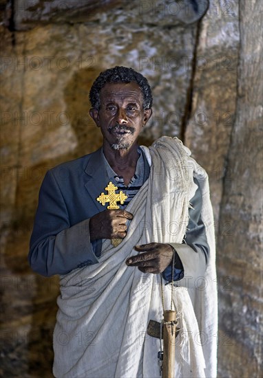 Orthodox priest inside the rock church Medhane Alem