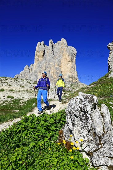 Hikers on the south side of the Three peaks of Lavaredo on the way from the Auronzo hut to the Bullele Joch hut