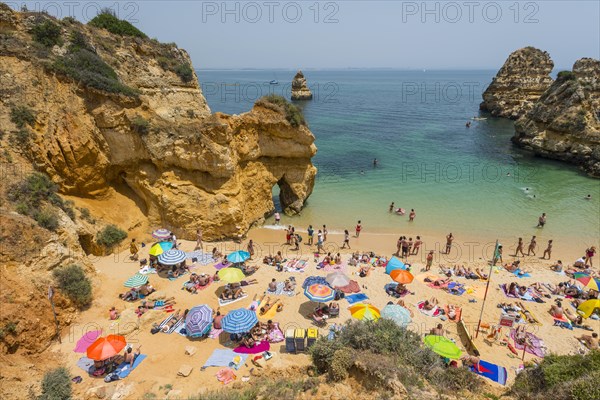 Tourists and bathers at the sandy beach