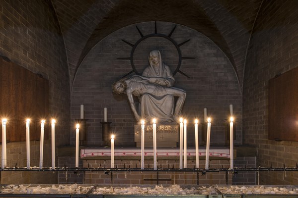 Pieta sculpture with candles