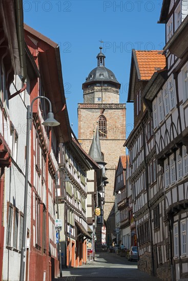 Narrow alley through half-timbered houses and Walpurgiskirche
