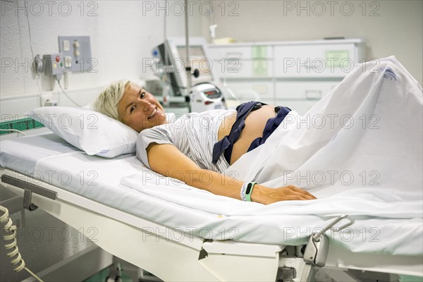 Pregnant woman with ctg recording the fetal heartbeat and the uterine contractions