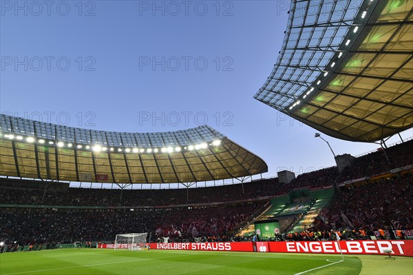 Football stadium illuminated with perimeter advertising