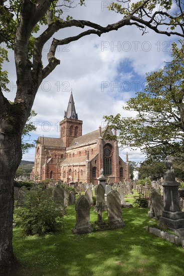 Old gravestones on cemetery and Romanesque-Norman cathedral St. Magnus