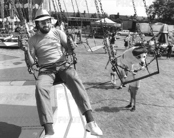 Man and Jack Russell Terrier driving a carousel