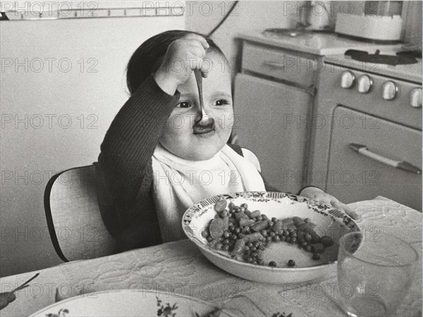 Toddler eats with spoon