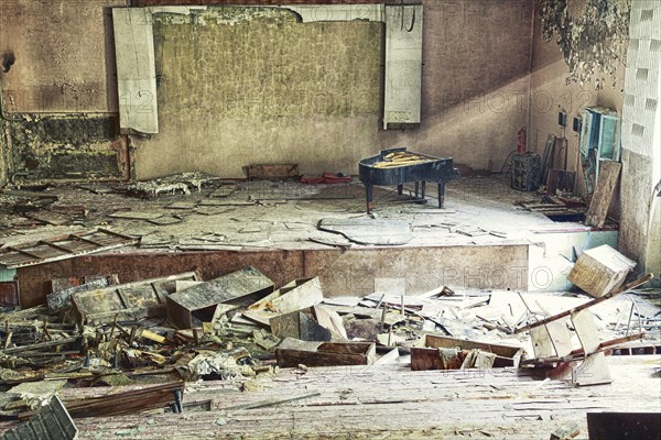 Stage with concert grand in destroyed hall