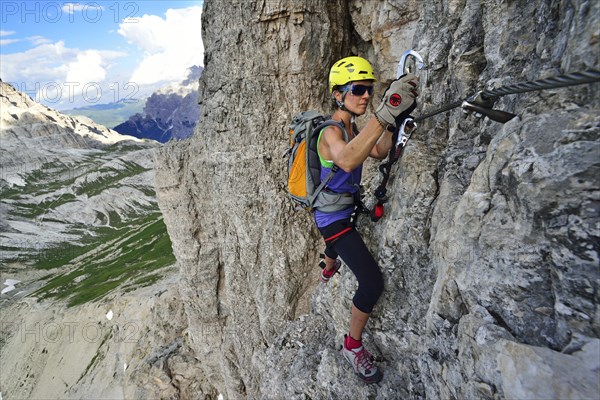 Female climber in the ladder at the Toblinger Knoten