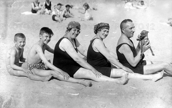 Family on the beach with dog ca. 1928