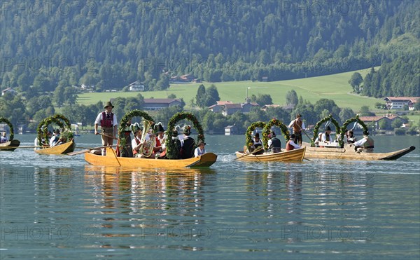 Men wearing traditional costumes in festively decorated squares