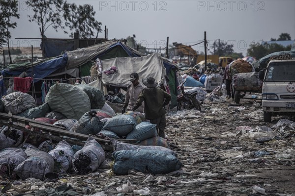 Garbage collectors on rubbish dump on the outskirts