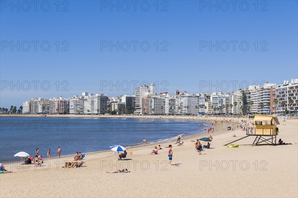 Swimmers at the city beach and skyscrapers in Montevideo