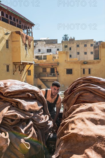 Worker dyeing leather