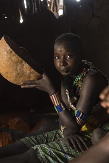 Woman drinking from calabash