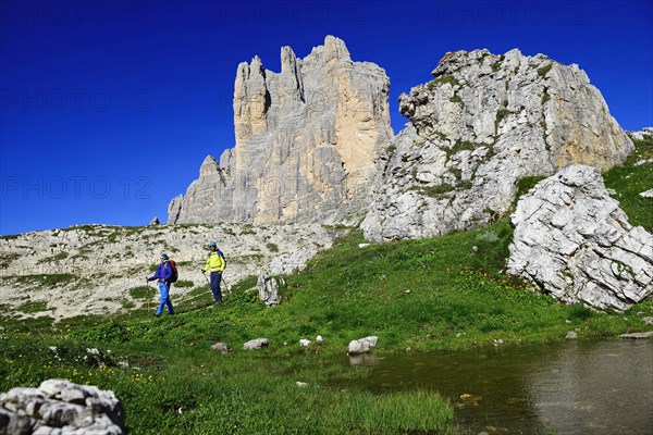 Hikers on the south side of the Three peaks of Lavaredo on the way from the Auronzo hut to the Bullele Joch hut