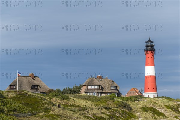 Lighthouse with thatched houses