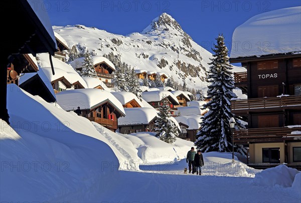 Village road with snow-covered chalets