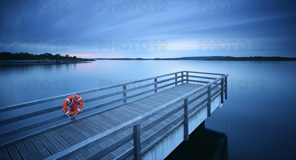 Pier in the harbour with life belt