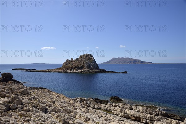 Il Faraglione rocky island with Favignana Island in the back