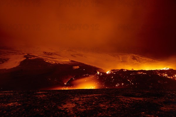 Glowing lava and lava flow at night on Fimmvorouhals volcano