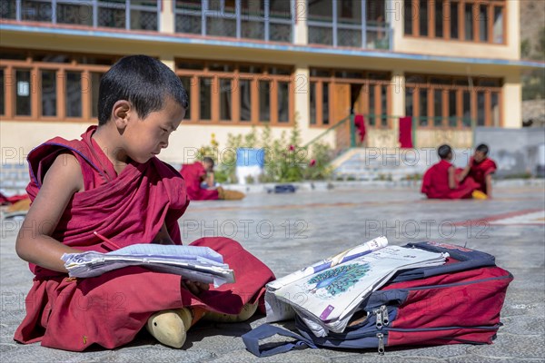 A small school boy studding outside at Likir Monastery or Likir Gompa