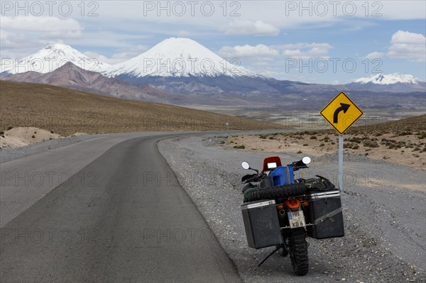 Heavily packed motorcycle at the roadside behind the volcano Pomerape