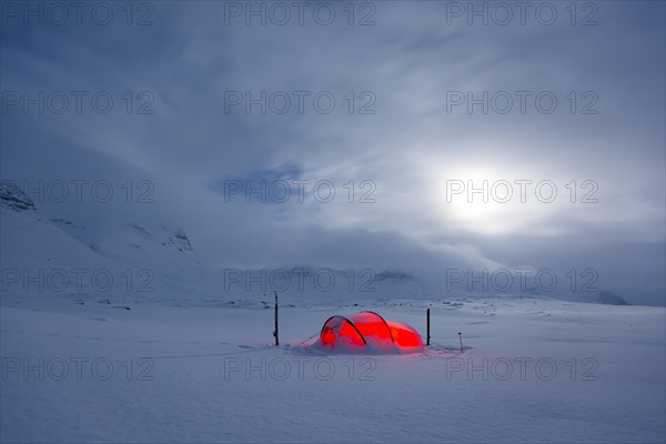 Tent by full moon in the snow
