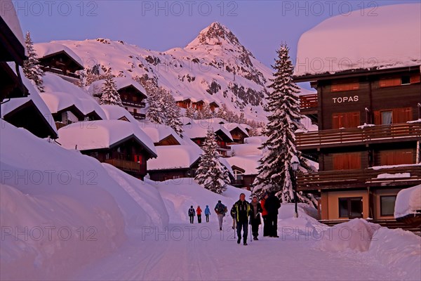 Village road with deep snow against Bettmerhorn 2872m at dusk